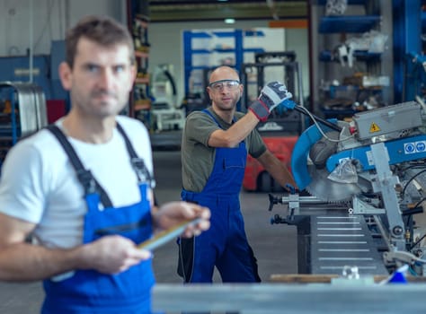 two worker in factory on work bench