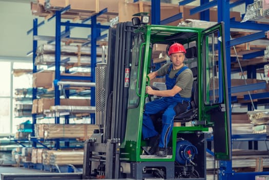 one worker in factory in lift truck with thumb up