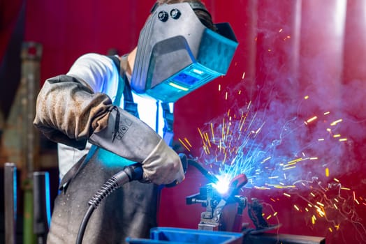 man welding metal in the factory