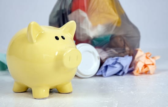 garbage bag with defferent content with yellow piggy bank