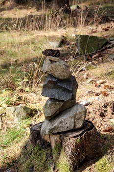 Stones as a pyramid stacked on a tree stump