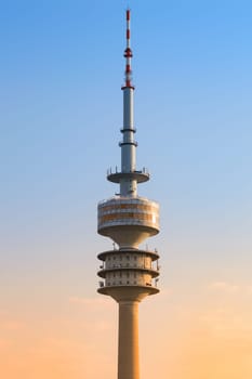 Munich, Germany - April 22, 2018: Olympic broadcast tower or Olympiaturm in the Olympic Park. Close up photo against clear morning sky.