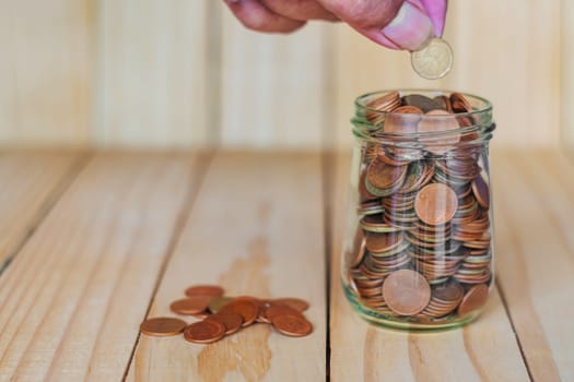 Save money and account banking for finance business concept, Hand with coin money on business office table, Savings for retirement and investing concept