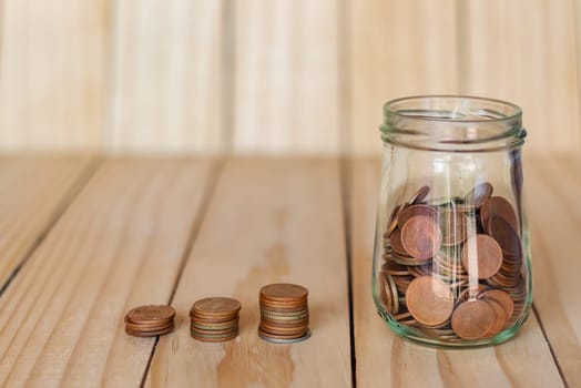 Save money and account banking for finance business concept, Coin money in bottle on business office table, Savings for retirement and investing concept