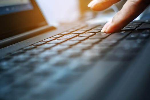 Networking and connecting concept, Keyboard with hand human on notebook computer blurred background