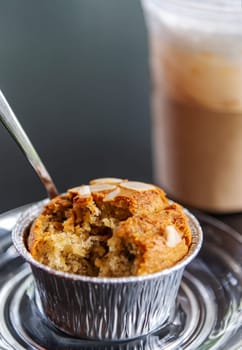 Banana cupcake with ice milk tea and water drink blurred background