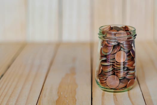 Save money and account banking for finance business concept, Coin money in bottle on business office table, Savings for retirement and investing concept