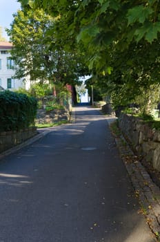 on old street with a step hill up to the top old house