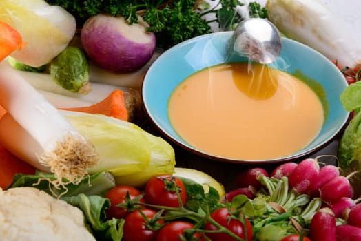 plate of pumpkin soup with  several vegetables