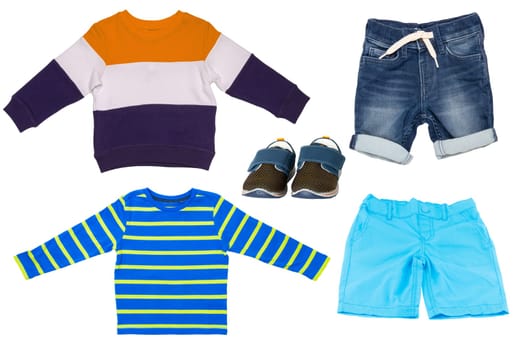 Collage set of children clothes. Short pants, short jeans, shoes , shirt and a sweater for child boy isolated on a white background. Concept spring autumn and summer clothes.