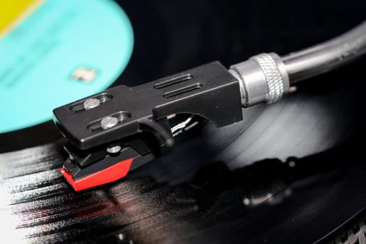 Detail of a vinyl record player with a long-playing record