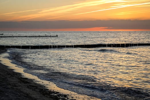Breakwater built of wooden logs by the Baltic Sea.