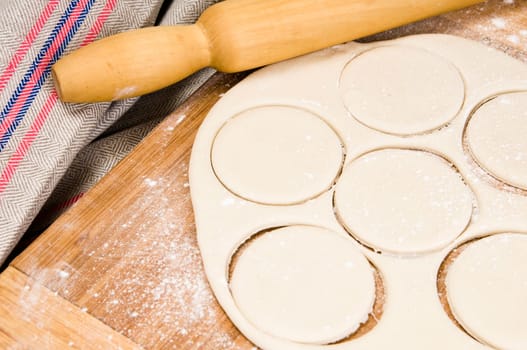 fresh raw dough and rolling pin for baking