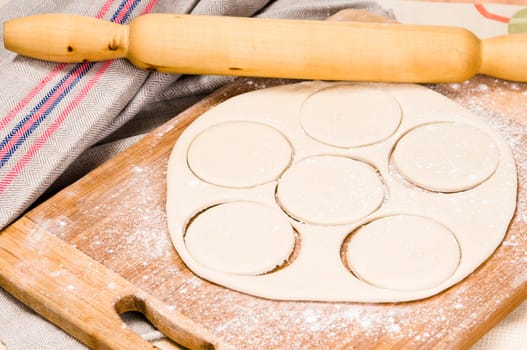 fresh raw dough and rolling pin for baking