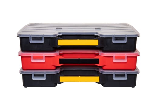 Equipment of craftsman. Three professional plastic storage boxes for screws, bolts, dowels and some other components isolated on a white background. Handyman accessories.