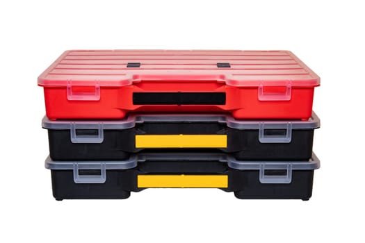 Equipment of craftsman. Three professional plastic storage boxes for screws, bolts, dowels and some other components isolated on a white background. Handyman accessories.