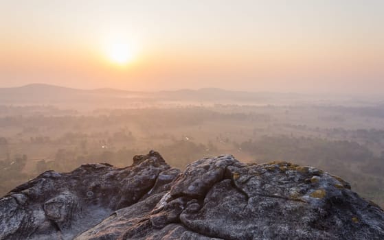 Left Sunrise at Pha Hua Rue Phayao Attractions Thailand Travel. Natural stone or rock mountain with sunrise sky and mist at Phayao northern Thailand travel