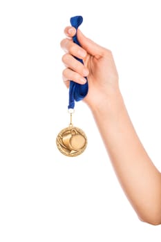 Girl hand raised holding gold medal against white background award and victory concept