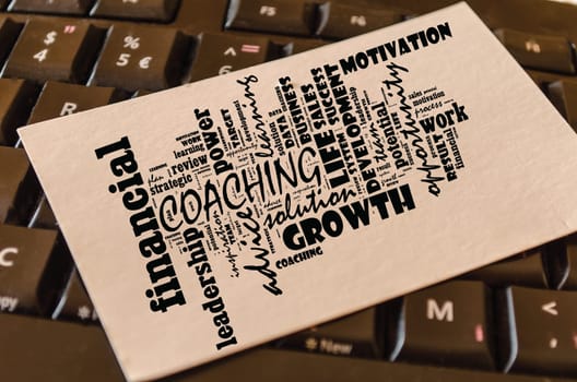Coaching word cloud collage over keyboard background