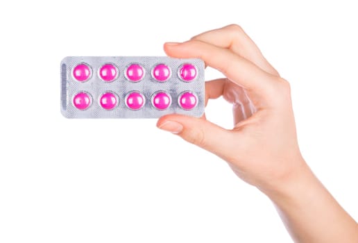 Woman hand holding pills tablet. Female hand holding prescription pill over white background.