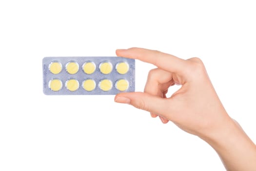 Woman hand holding pills tablet. Female hand holding prescription pill over white background.