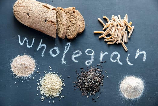 Wholegrain products on the dark wooden background