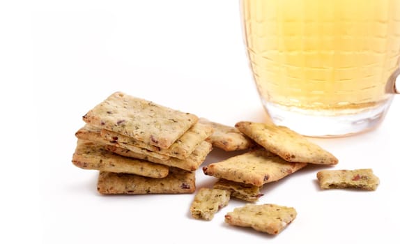 Still life of glass mug with light beer, and cereal crispbread on a white background