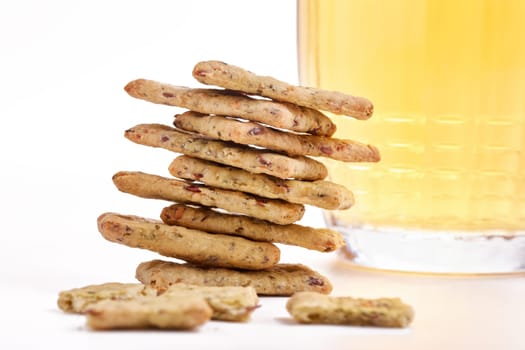 Still life of glass mug with light beer, and cereal crispbread on a white background