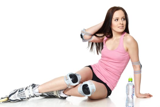 The beautiful young woman in rollerskates on a white background.
