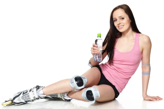 The beautiful young woman in rollerskates on a white background.
