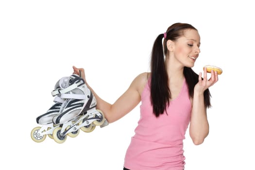 Young sporty woman with rollerskates and donut on a white background. Choice problem.