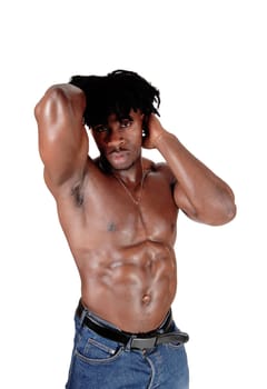 A young African American male standing shirtless with his hands on his.head showing his muscular body, isolated for white background.