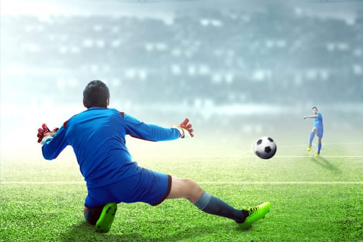 Asian football player man kicking the ball to the goal on football field at stadium