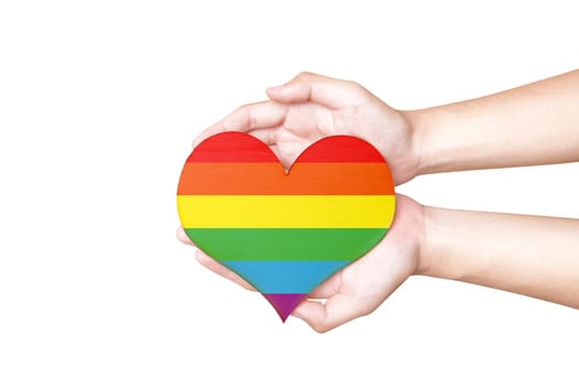 Human hands holding heart with rainbow flag as a symbol of LGBT isolated over white background