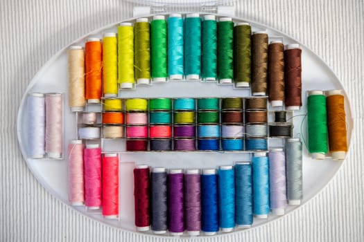 a lot of colorful yarn in organizer box
