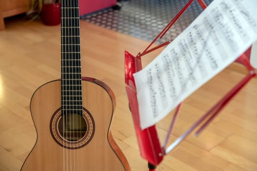acoustic guitar with music stand in living room