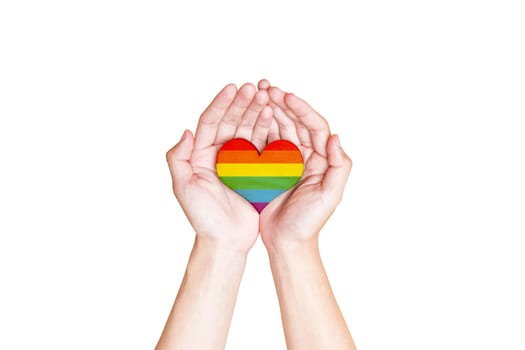 Human hands holding heart with rainbow flag as a symbol of LGBT isolated over white background