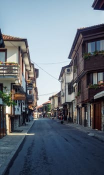 Nesebar, Bulgaria - September 10, 2014: Asphalt street and ancient architecture in old town Nessebar, Bulgaria. UNESCO world heritage site. Vertical shot.