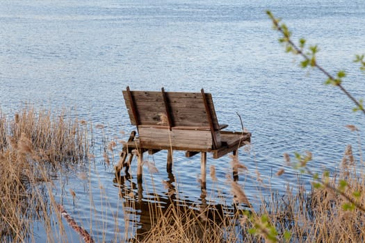 bench on a pier at a beautiful misty lake and fog, solitary, symbol of relax, isolation, reflections, thoughts, perfect spot for fishing