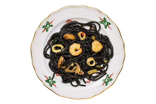Top view of italian black pasta with seafood. Closeup of mediterranean black noodles with cuttlefish ink, mussels and shrimps isolated on a colorful plate. Macro.