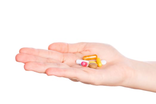 Pills in woman hand isolated on white background. Woman hand holding pills on white