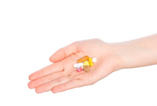 Pills in woman hand isolated on white background. Woman hand holding pills on white
