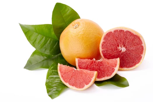 Fresh juicy whole grapefruit with green leaves and appetizing slices of ripe grapefruit on a white background.