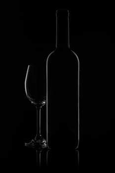 Silhouette of wine bottle and empty wineglass on a black background with reflection. Contour with gradient and highlights