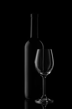 Silhouette of wine bottle and empty wineglass on a black background with reflection. Contour with gradient and highlights
