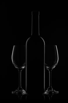 Silhouette of wine bottle and two empty wineglasses on a black background with reflection. Contour with gradient and highlights