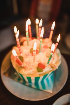 Close-up shot of a birthday cake with candles.