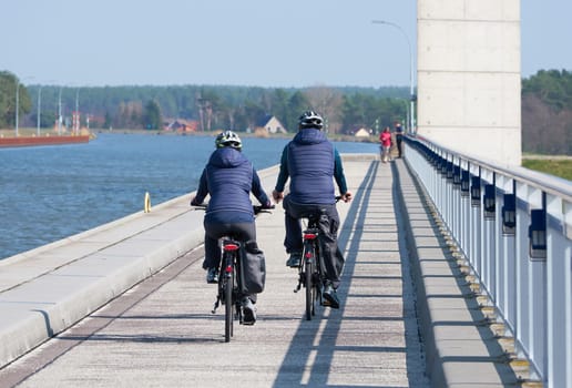 Two cyclists crossing the trough bridge over the River Elbe at Hohenwarthe in Germany