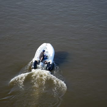 a motorboat driver photographed on the river Elbe near Magdeburg from a bridge