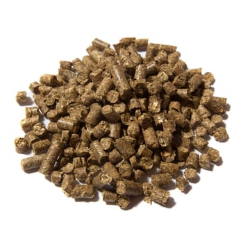 Light brown pressed solid wooden pellets granules on white background
